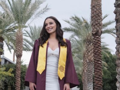 Liv Cowherd is posing in her graduation gown.